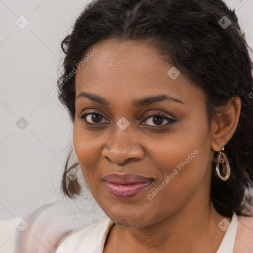 Joyful black young-adult female with long  brown hair and brown eyes