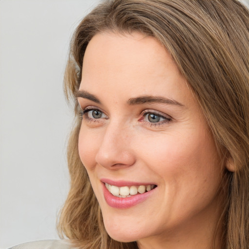 Joyful white young-adult female with medium  brown hair and green eyes