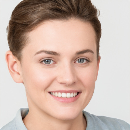 Joyful white young-adult female with short  brown hair and grey eyes