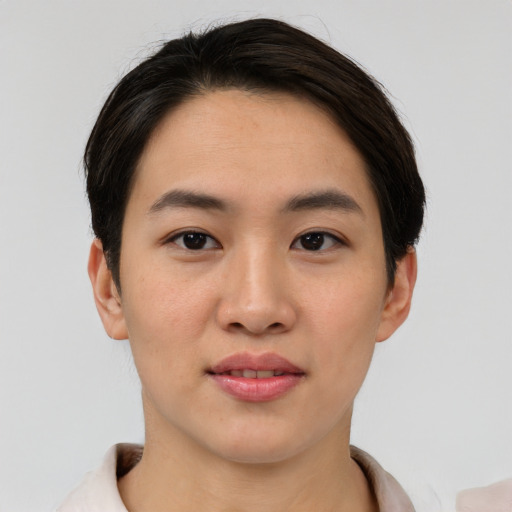Joyful asian young-adult female with short  brown hair and brown eyes