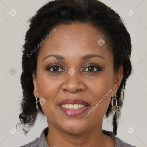 Joyful black adult female with medium  brown hair and brown eyes