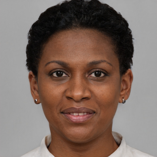 Joyful black adult female with short  black hair and brown eyes