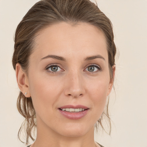 Joyful white young-adult female with medium  brown hair and grey eyes