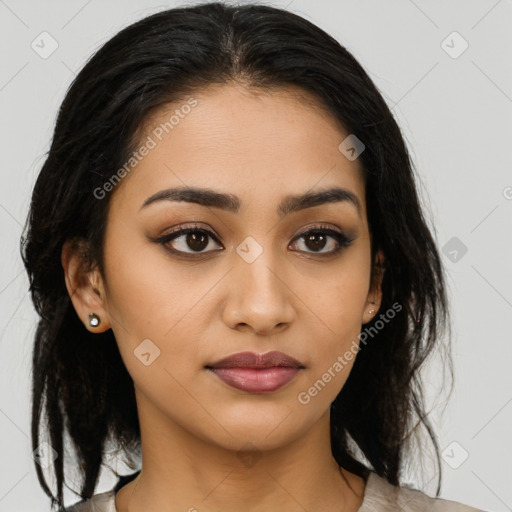 Joyful latino young-adult female with medium  brown hair and brown eyes