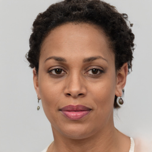 Joyful black adult female with short  brown hair and brown eyes