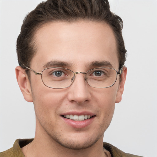 Joyful white adult male with short  brown hair and grey eyes