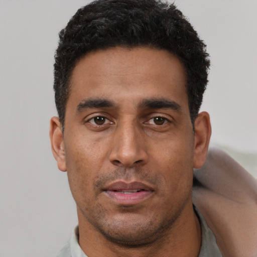 Neutral latino young-adult male with short  brown hair and brown eyes