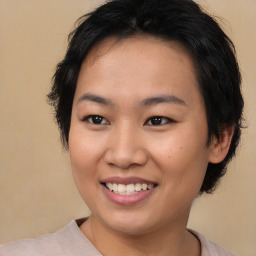 Joyful asian young-adult female with medium  brown hair and brown eyes