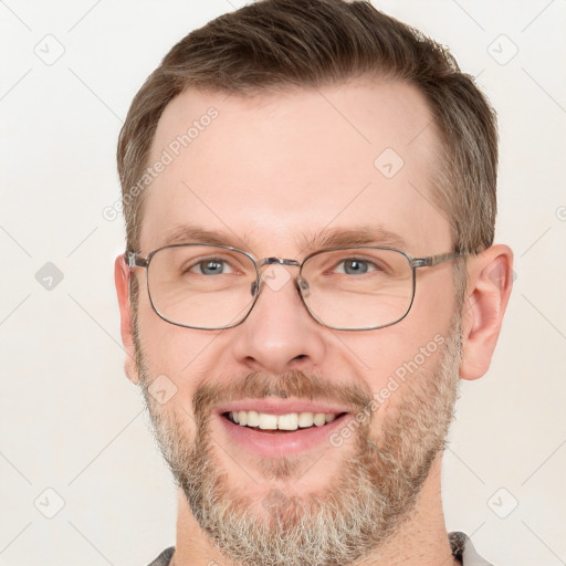 Joyful white adult male with short  brown hair and grey eyes