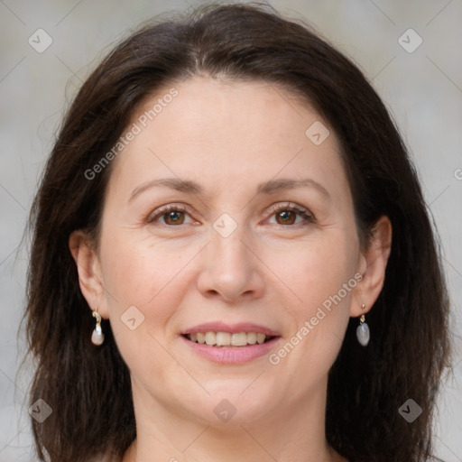 Joyful white adult female with medium  brown hair and brown eyes