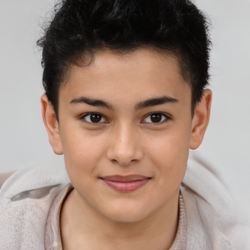 Joyful latino child male with short  brown hair and brown eyes