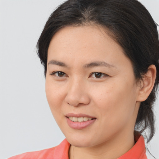 Joyful asian young-adult female with medium  brown hair and brown eyes