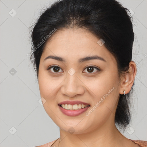 Joyful latino young-adult female with medium  brown hair and brown eyes