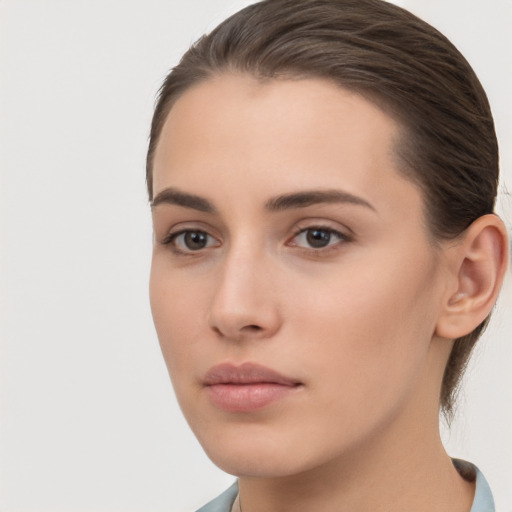 Neutral white young-adult female with long  brown hair and brown eyes