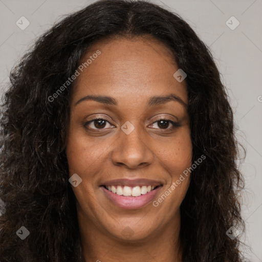 Joyful black young-adult female with long  brown hair and brown eyes