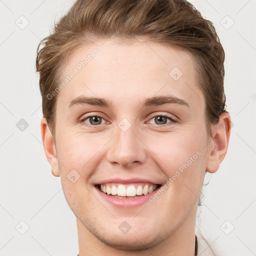 Joyful white young-adult female with short  brown hair and grey eyes