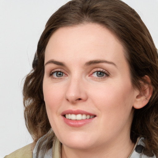 Joyful white young-adult female with medium  brown hair and green eyes