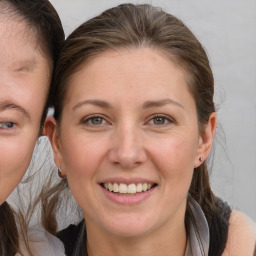 Joyful white adult female with medium  brown hair and brown eyes