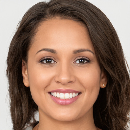 Joyful white young-adult female with long  brown hair and brown eyes