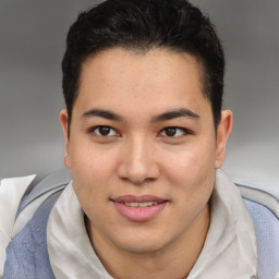 Joyful latino young-adult male with short  brown hair and brown eyes