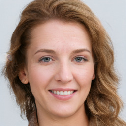 Joyful white young-adult female with long  brown hair and blue eyes