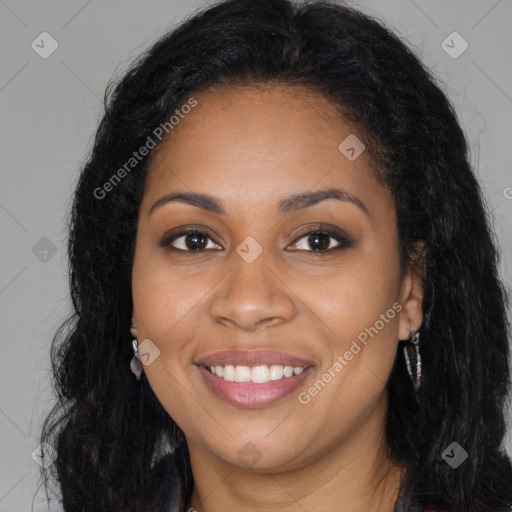 Joyful black young-adult female with long  brown hair and brown eyes