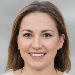 Joyful white young-adult female with medium  brown hair and grey eyes