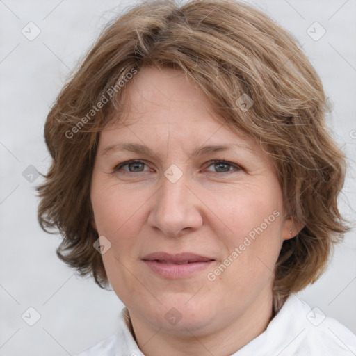 Joyful white adult female with medium  brown hair and blue eyes