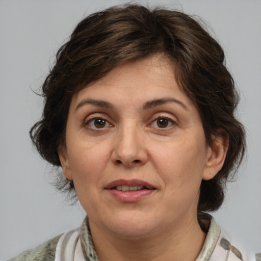 Joyful white adult female with medium  brown hair and brown eyes