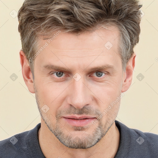 Joyful white adult male with short  brown hair and grey eyes