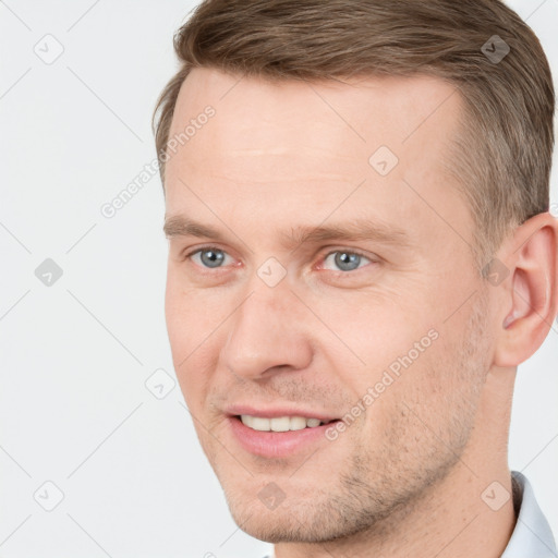 Joyful white adult male with short  brown hair and grey eyes