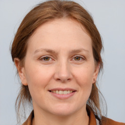 Joyful white adult female with medium  brown hair and brown eyes