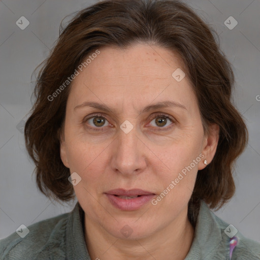 Joyful white adult female with medium  brown hair and blue eyes