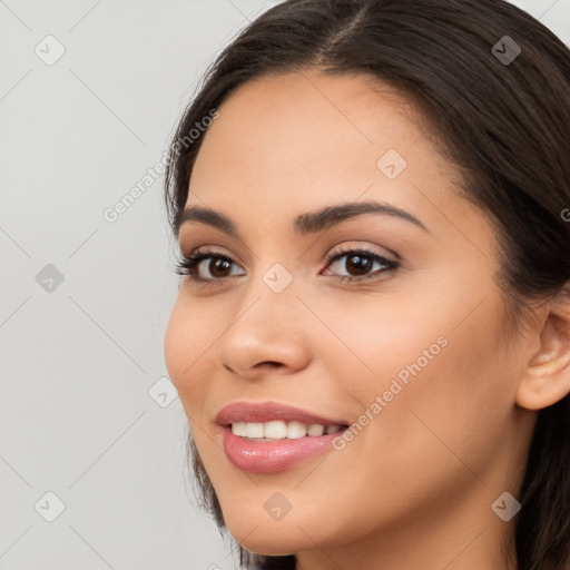 Joyful latino young-adult female with long  brown hair and brown eyes