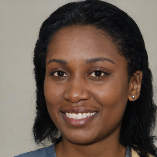 Joyful black young-adult female with medium  black hair and brown eyes