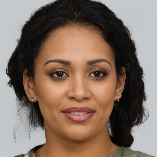 Joyful latino young-adult female with medium  brown hair and brown eyes