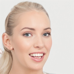 Joyful white young-adult female with long  brown hair and blue eyes