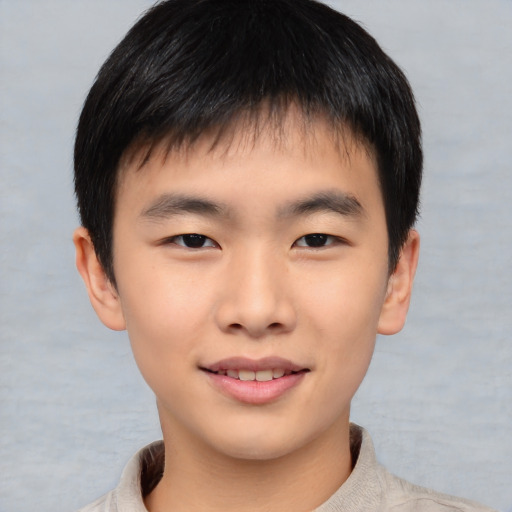 Joyful asian child male with short  brown hair and brown eyes