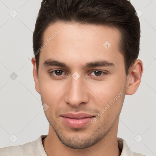 Joyful white young-adult male with short  brown hair and brown eyes