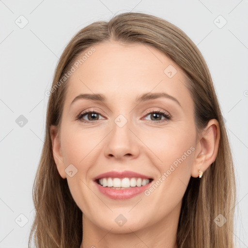 Joyful white young-adult female with long  brown hair and blue eyes