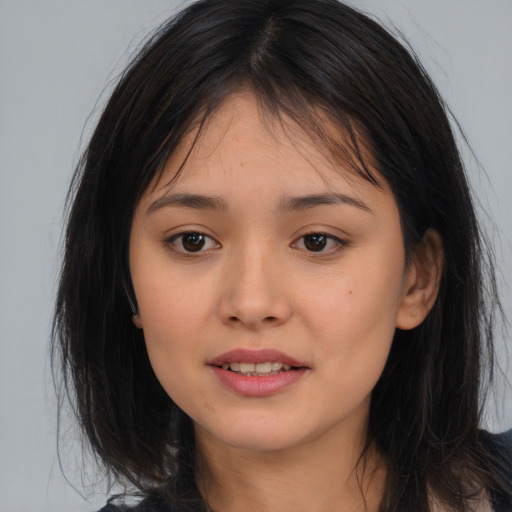 Joyful asian young-adult female with long  brown hair and brown eyes