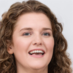 Joyful white young-adult female with long  brown hair and blue eyes