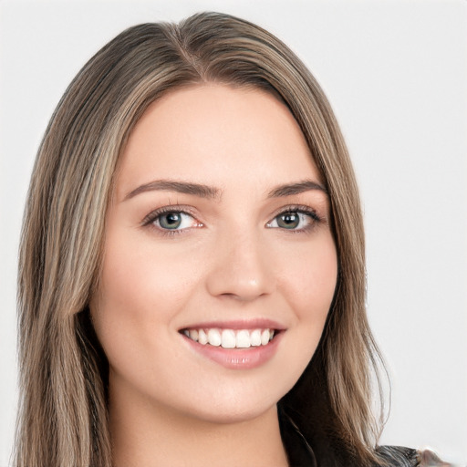 Joyful white young-adult female with long  brown hair and green eyes