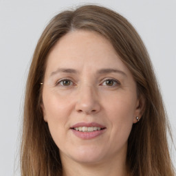 Joyful white adult female with long  brown hair and grey eyes