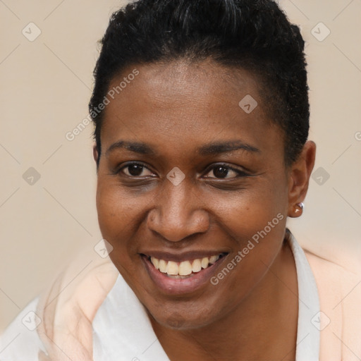 Joyful black young-adult female with short  brown hair and brown eyes