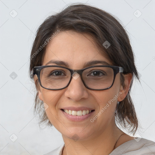 Joyful white adult female with medium  brown hair and brown eyes