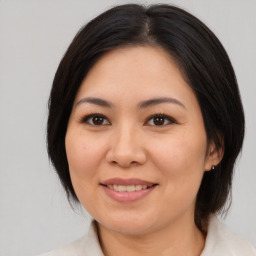 Joyful asian young-adult female with medium  brown hair and brown eyes