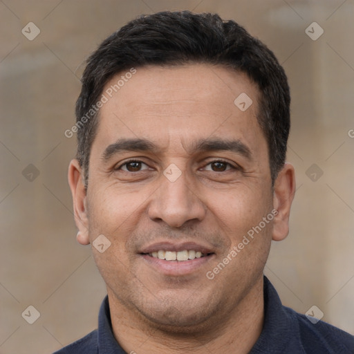 Joyful white adult male with short  black hair and brown eyes