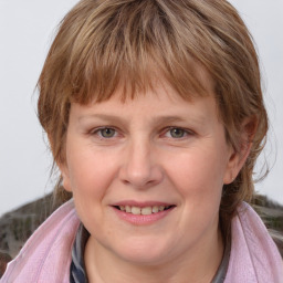 Joyful white young-adult female with medium  brown hair and blue eyes