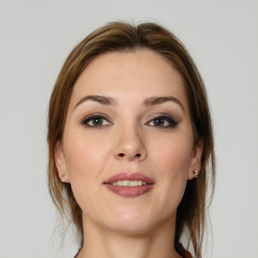 Joyful white young-adult female with medium  brown hair and grey eyes